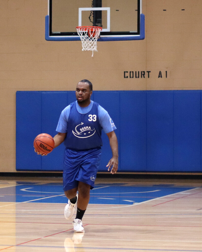 Basketball player dribbling on court.