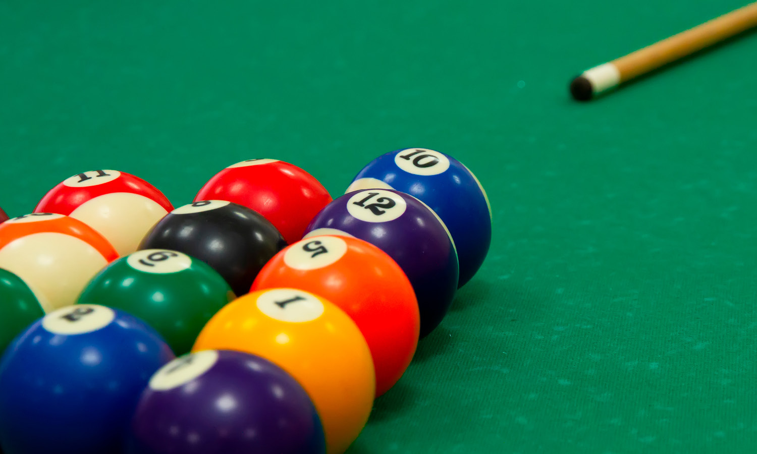 Pool table with balls and cue