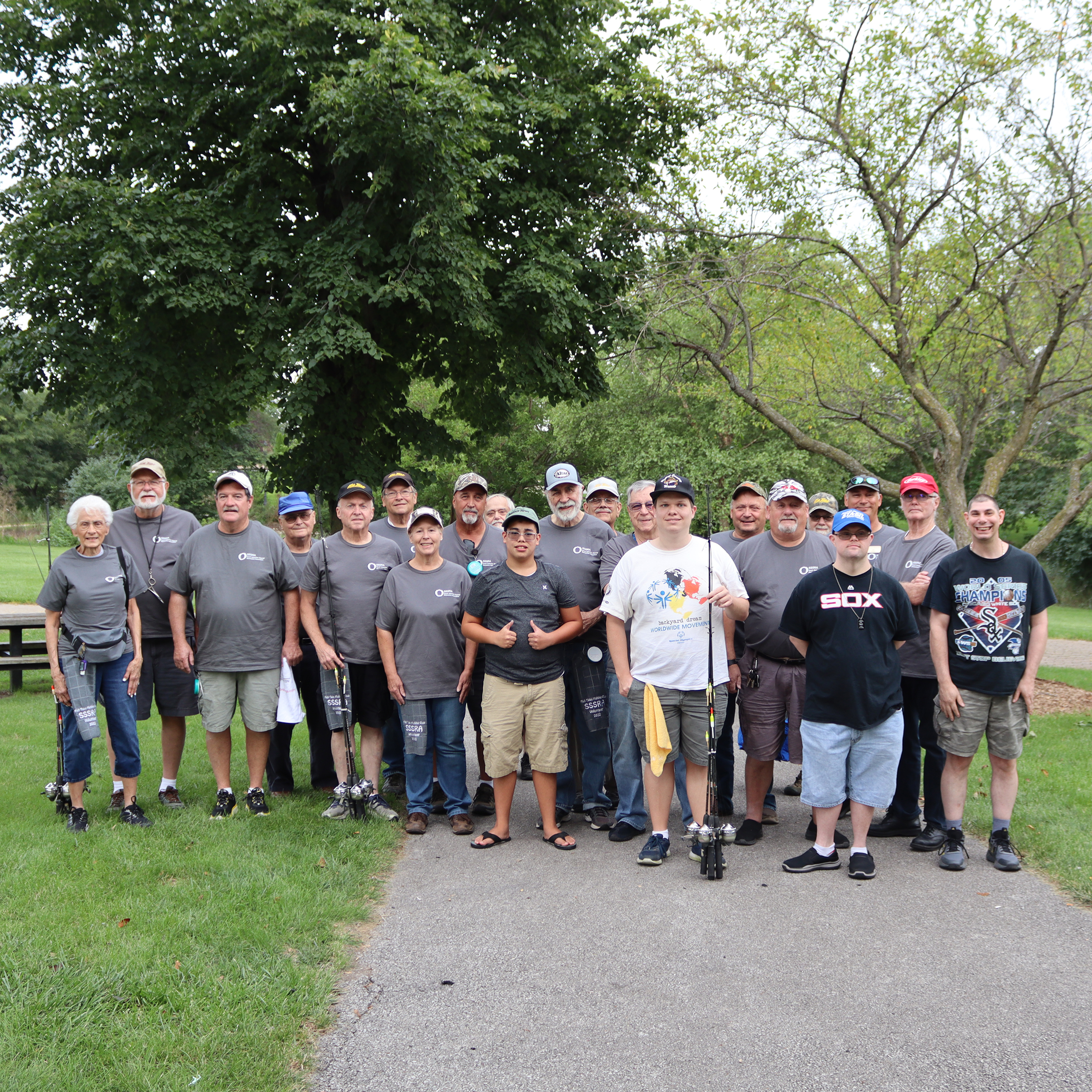 SSSRA participants pose with volunteers from Fish Tales Fishing Club at our Learn to Fish program.